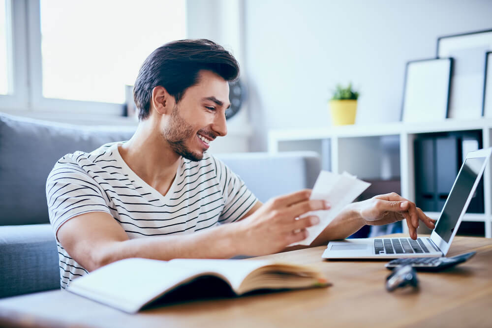 Man Researching Whilst Smiling