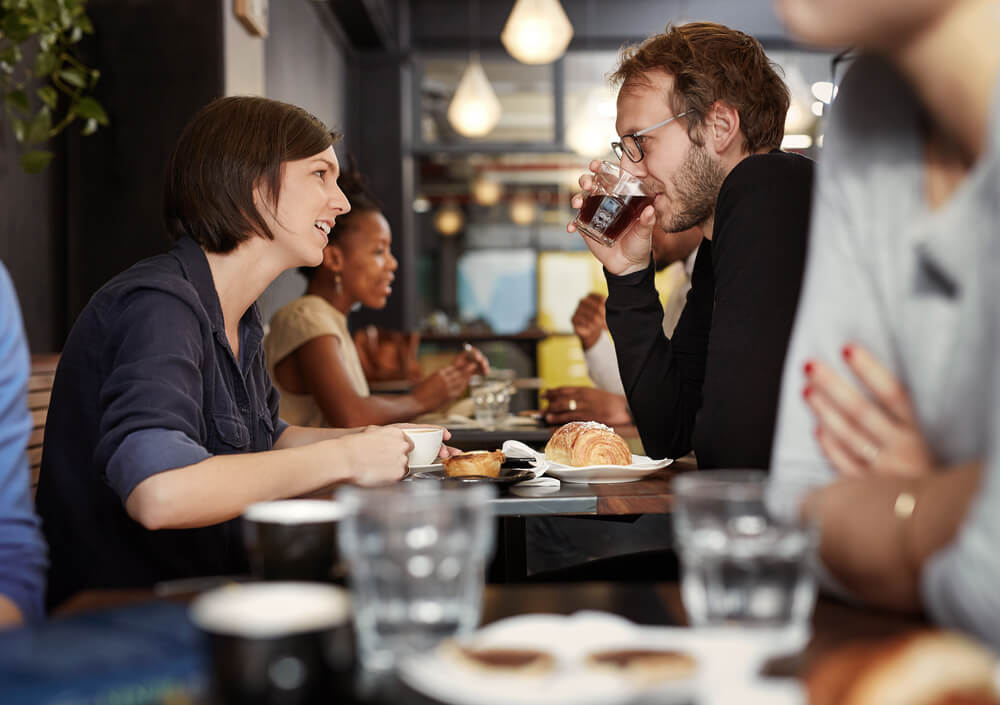 Lady and man drinking coffee together.