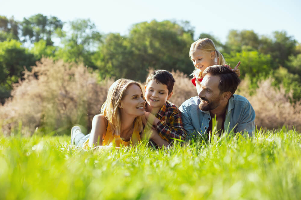 Family sat at the park together playing