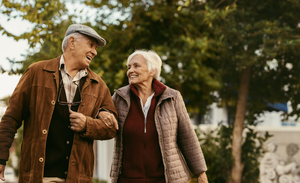 Older couple walking together.