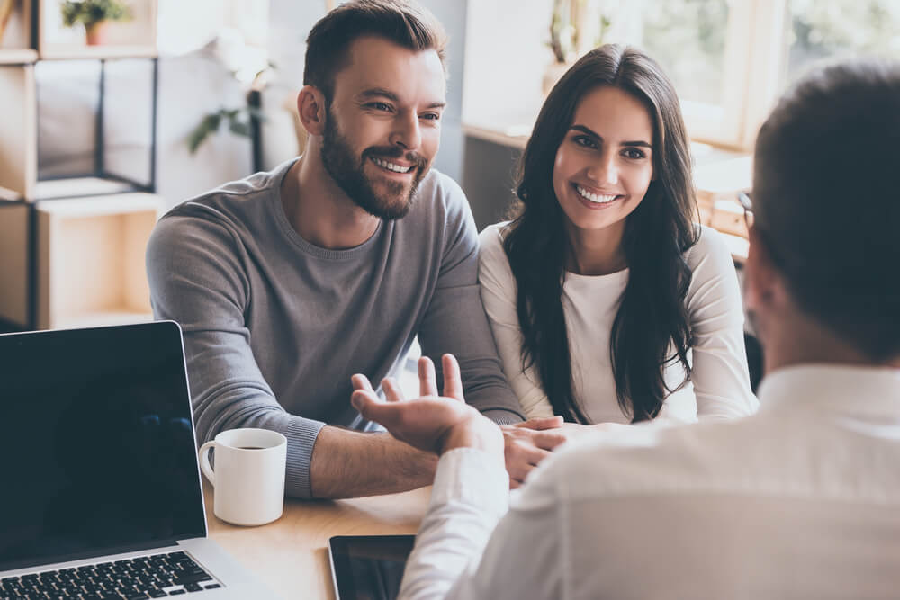 A couple speaking with an advisor.